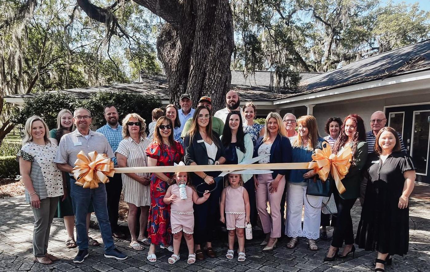 Members of the Thomasville business community at The Abide Collective's ribbon cutting, gathered under a live oak